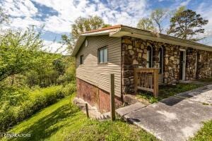 view of side of home with stone siding