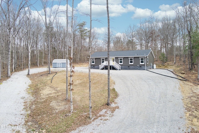 101 Woods Hollow Ln, Crossville, TN 38571 - view of front of property featuring crawl space, a shed, gravel driveway, and an outbuilding