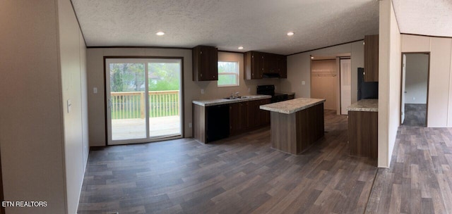 kitchen featuring dark wood-style floors, light countertops, and black appliances