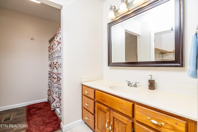 709 Head Of Creek Rd, Sweetwater, TN 37874 - full bathroom with vanity, baseboards, wood finished floors, and curtained shower