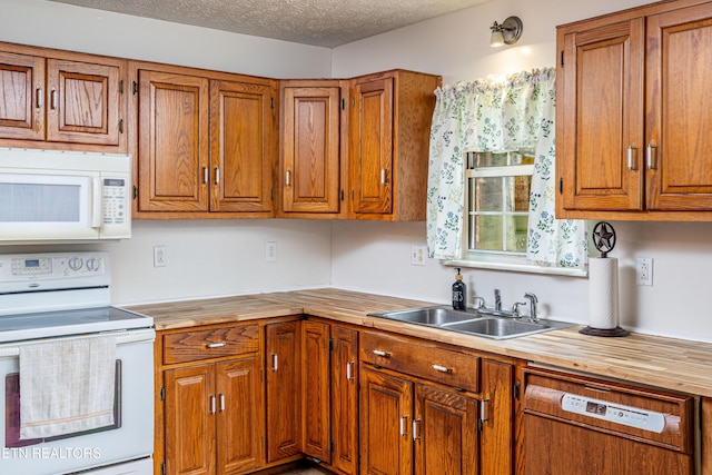 709 Head Of Creek Rd, Sweetwater, TN 37874 - kitchen featuring white appliances, a sink, butcher block countertops, brown cabinetry, and a textured ceiling