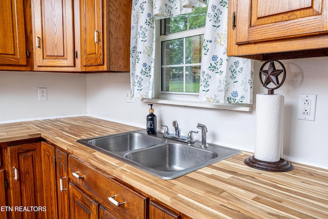 709 Head Of Creek Rd, Sweetwater, TN 37874 - kitchen with butcher block countertops, a sink, brown cabinets, and wood finished floors