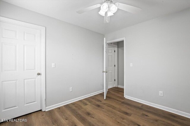 174 Sandy Hill Rd, Lafollette, TN 37766 - unfurnished bedroom with dark wood-style flooring, ceiling fan, and baseboards