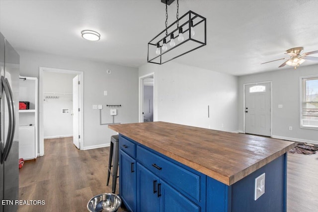 174 Sandy Hill Rd, Lafollette, TN 37766 - kitchen with dark wood-style flooring, butcher block countertops, blue cabinets, and freestanding refrigerator