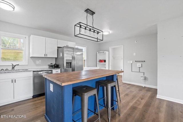174 Sandy Hill Rd, Lafollette, TN 37766 - kitchen featuring butcher block counters, appliances with stainless steel finishes, a sink, white cabinetry, and dark wood-type flooring