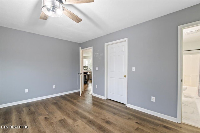 174 Sandy Hill Rd, Lafollette, TN 37766 - unfurnished bedroom featuring a ceiling fan, wood finished floors, connected bathroom, and baseboards