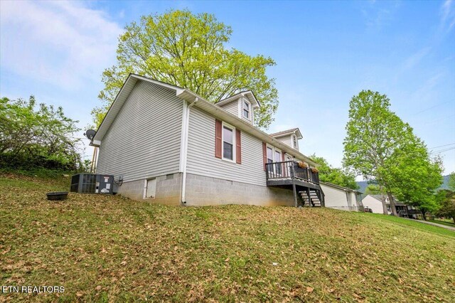 174 Sandy Hill Rd, Lafollette, TN 37766 - view of property exterior featuring a wooden deck, stairs, and a lawn