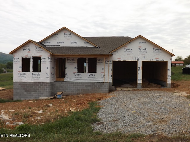 128 Nevils St, Harrogate, TN 37752 - property under construction featuring driveway, roof with shingles, a garage, and covered porch