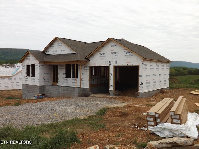128 Nevils St, Harrogate, TN 37752 - property in mid-construction with covered porch, gravel driveway, a garage, and a shingled roof