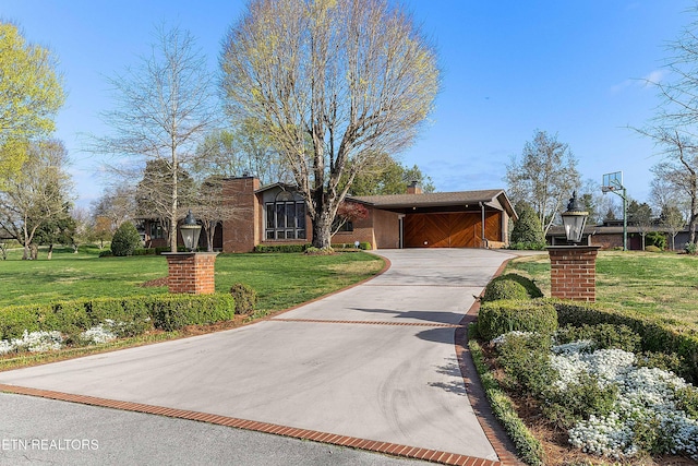 212 Douglas Ave, Sweetwater, TN 37874 - view of front facade with a front yard, a carport, a garage, a chimney, and driveway