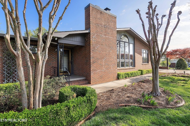 212 Douglas Ave, Sweetwater, TN 37874 - view of property exterior with brick siding and a chimney
