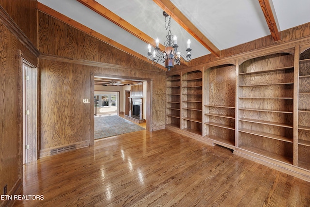 212 Douglas Ave, Sweetwater, TN 37874 - unfurnished room with wood walls, vaulted ceiling with beams, a chandelier, and wood finished floors