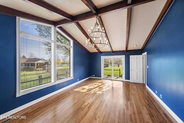 212 Douglas Ave, Sweetwater, TN 37874 - empty room with vaulted ceiling with beams, baseboards, an inviting chandelier, and wood finished floors