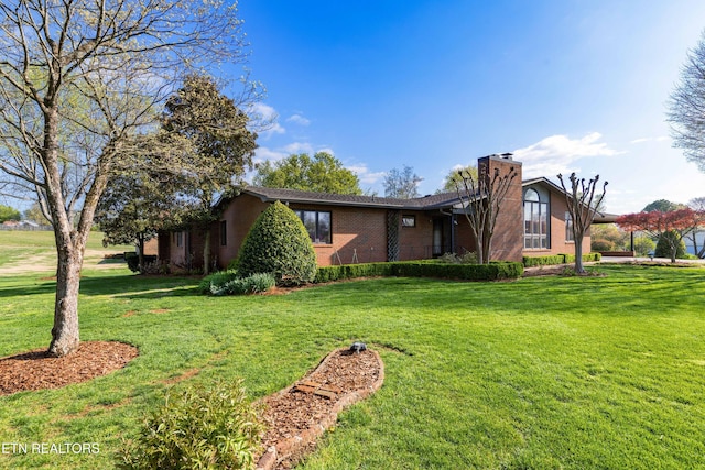212 Douglas Ave, Sweetwater, TN 37874 - view of property exterior featuring brick siding, a yard, and a chimney