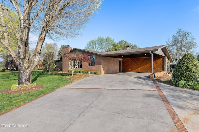 212 Douglas Ave, Sweetwater, TN 37874 - mid-century inspired home featuring a carport, a front lawn, brick siding, a chimney, and driveway