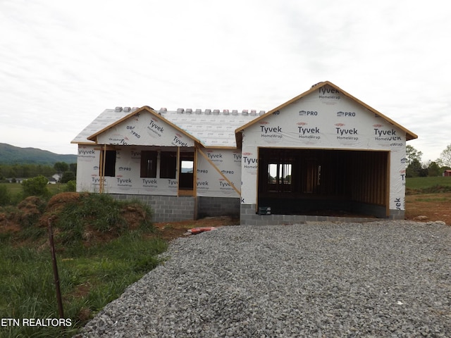 152 Nevils St, Harrogate, TN 37752 - property under construction with gravel driveway, an attached garage, and covered porch