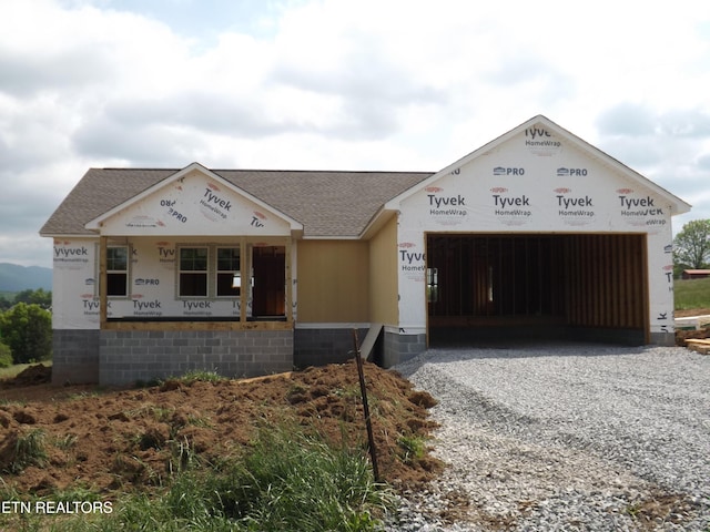 152 Nevils St, Harrogate, TN 37752 - property under construction with gravel driveway, an attached garage, roof with shingles, and a porch