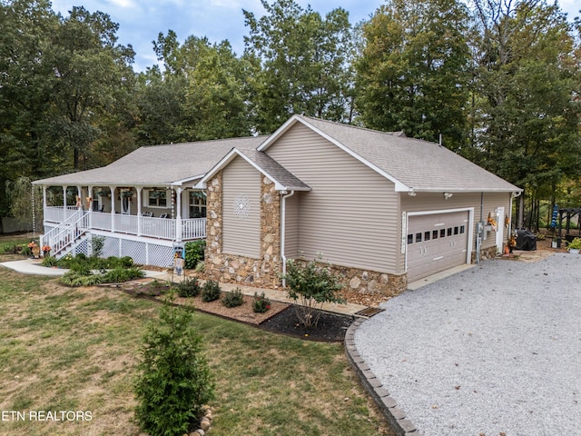533 T Rd, Monterey, TN 38574 - ranch-style house with a porch, gravel driveway, stone siding, a front lawn, and an attached garage