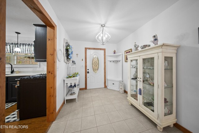 533 T Rd, Monterey, TN 38574 - foyer with light tile patterned floors, baseboards, and an inviting chandelier