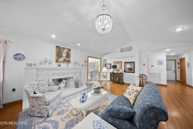 533 T Rd, Monterey, TN 38574 - living room featuring a notable chandelier, vaulted ceiling, and wood finished floors