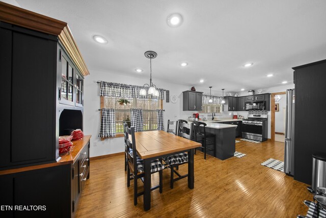 533 T Rd, Monterey, TN 38574 - dining room featuring baseboards, recessed lighting, an inviting chandelier, and wood finished floors