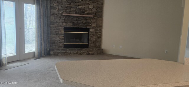 139 Fairhaven Dr, Crossville, TN 38558 - unfurnished living room with carpet flooring and a stone fireplace