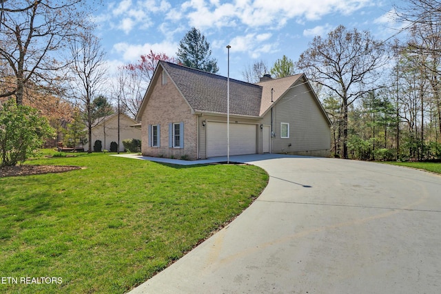 222 Pomeroy Dr, Crossville, TN 38558 - view of home's exterior featuring a garage, a lawn, brick siding, a chimney, and driveway