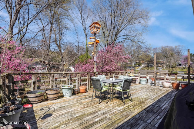 wooden deck featuring outdoor dining area