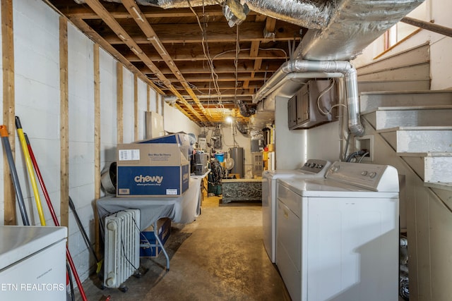 unfinished below grade area with stairway and washer and clothes dryer