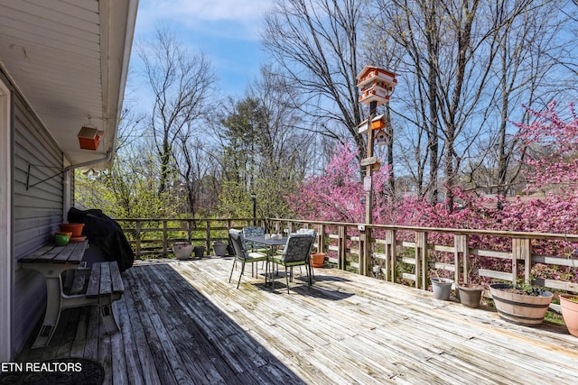 wooden terrace featuring outdoor dining area