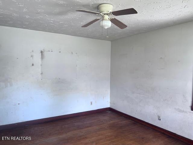 unfurnished room featuring a ceiling fan, a textured ceiling, baseboards, and wood finished floors