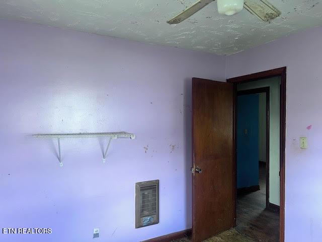 spare room featuring heating unit and a textured ceiling