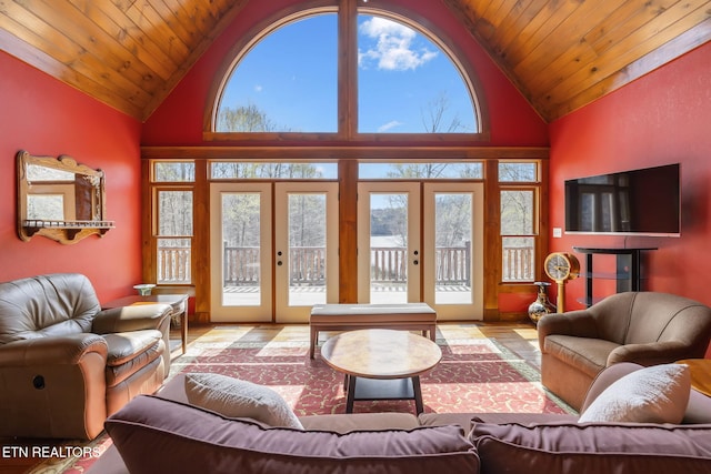 living area with a wealth of natural light, wooden ceiling, and french doors