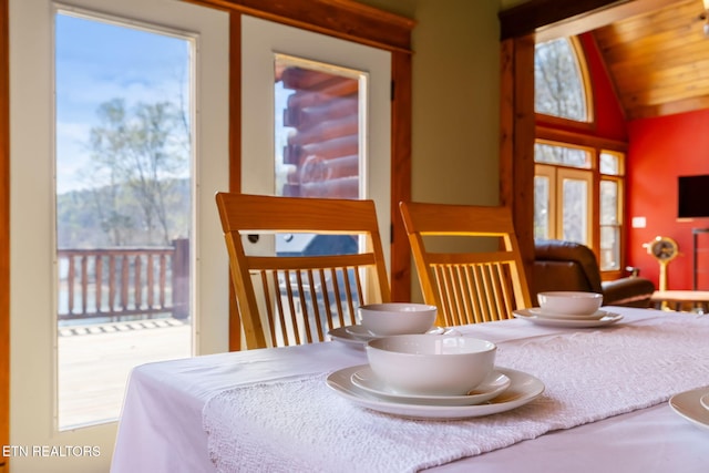 dining space featuring vaulted ceiling
