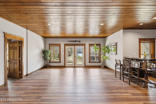 unfurnished dining area with recessed lighting, wood ceiling, baseboards, and wood finished floors