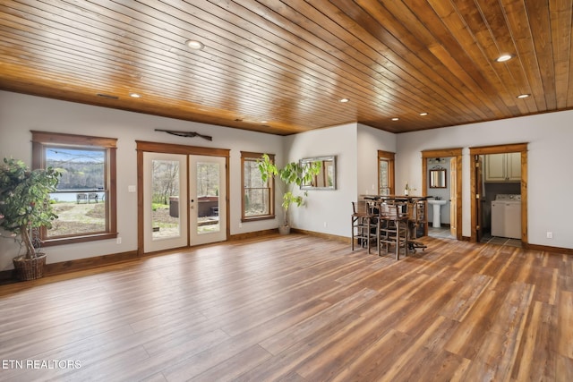 unfurnished dining area with recessed lighting, wooden ceiling, baseboards, washer / clothes dryer, and wood finished floors