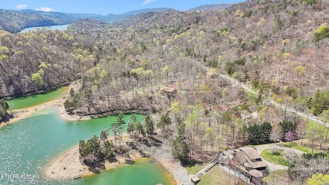 aerial view with a forest view and a water and mountain view