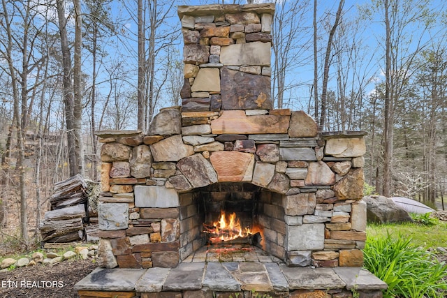 exterior details with an outdoor stone fireplace