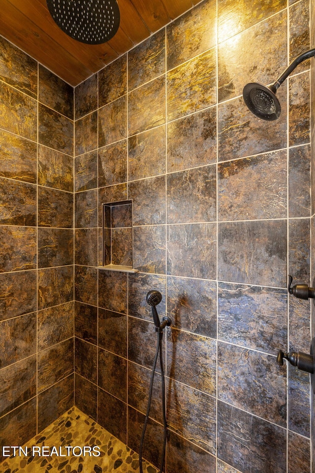 full bath with a tile shower