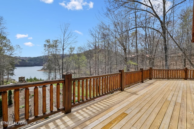 deck featuring a water view and a forest view