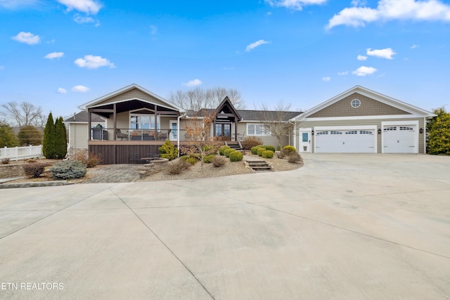 8207 Washington Pike, Corryton, TN 37721 - view of front of home featuring a porch, concrete driveway, and a garage
