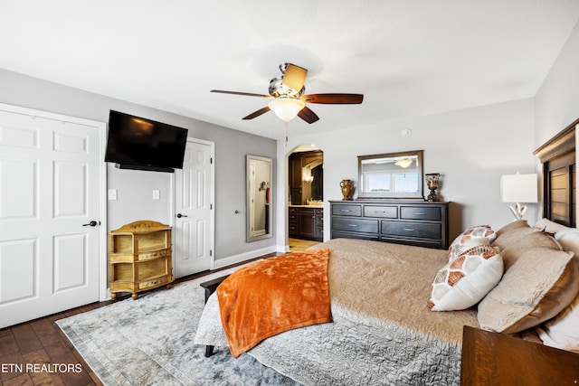 8207 Washington Pike, Corryton, TN 37721 - bedroom featuring wood-type flooring, baseboards, arched walkways, ensuite bath, and a ceiling fan