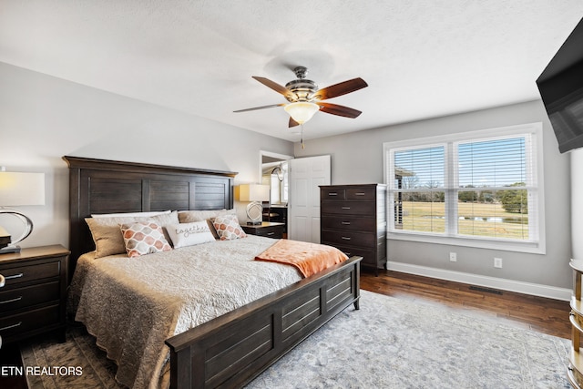 8207 Washington Pike, Corryton, TN 37721 - bedroom featuring baseboards, visible vents, dark wood-type flooring, and a ceiling fan