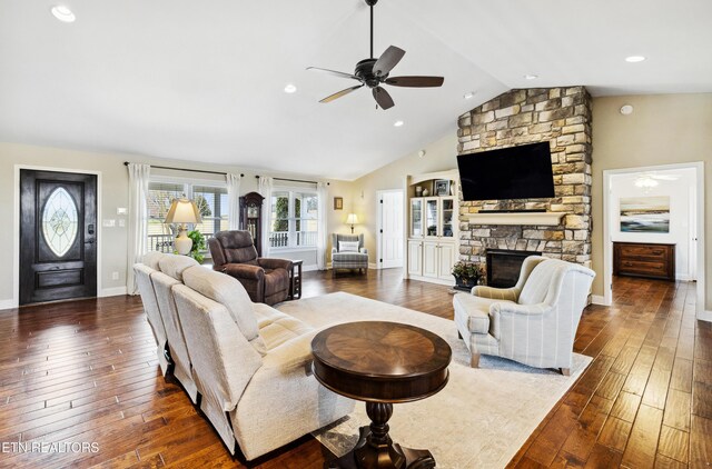 8207 Washington Pike, Corryton, TN 37721 - living room with a stone fireplace, lofted ceiling, baseboards, ceiling fan, and dark wood-type flooring