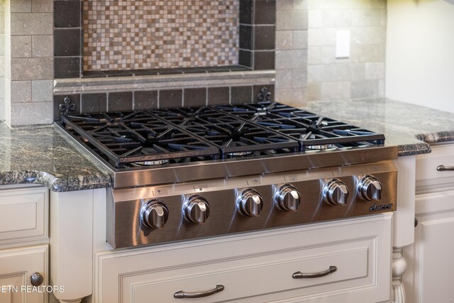 8207 Washington Pike, Corryton, TN 37721 - interior details with backsplash, stainless steel gas cooktop, and dark stone counters