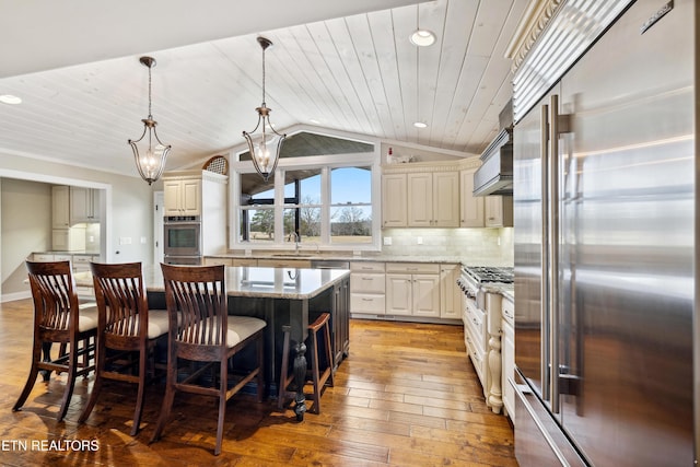 8207 Washington Pike, Corryton, TN 37721 - kitchen featuring light wood finished floors, stainless steel appliances, lofted ceiling, light stone counters, and backsplash
