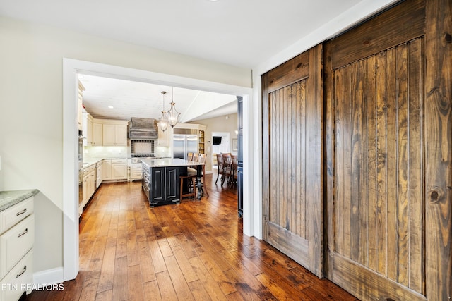 8207 Washington Pike, Corryton, TN 37721 - kitchen featuring a kitchen bar, dark wood-style flooring, backsplash, hanging light fixtures, and a notable chandelier