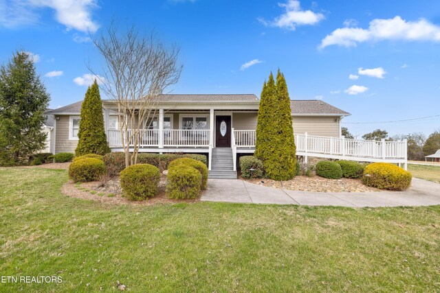 8207 Washington Pike, Corryton, TN 37721 - ranch-style house featuring a front yard and covered porch