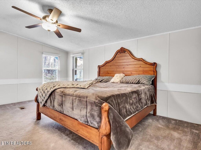 bedroom featuring visible vents, ornamental molding, a ceiling fan, a textured ceiling, and carpet floors