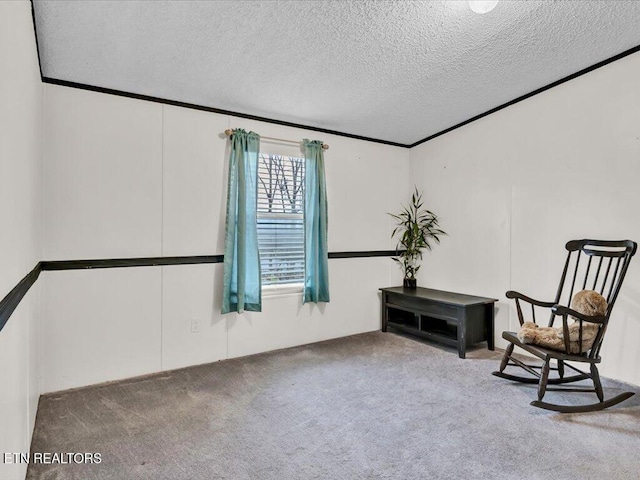 living area with crown molding, carpet, and a textured ceiling